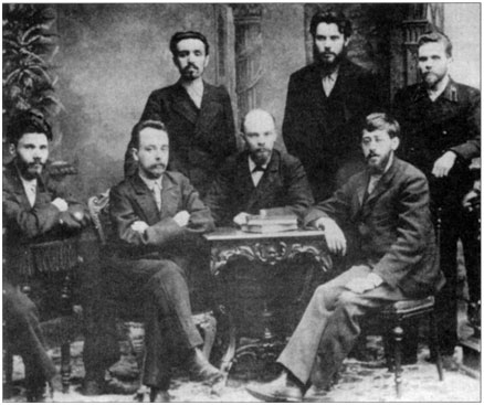 The leaders of the Petersburg League of Struggle for the Liberation of the  Working Class. Seated behind the table: Lenin. The picture was taken  when they were released from prison before being sent to Siberia.